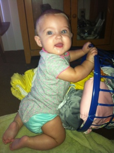 My daughter playing in her basket of freshly stuffed pockets!